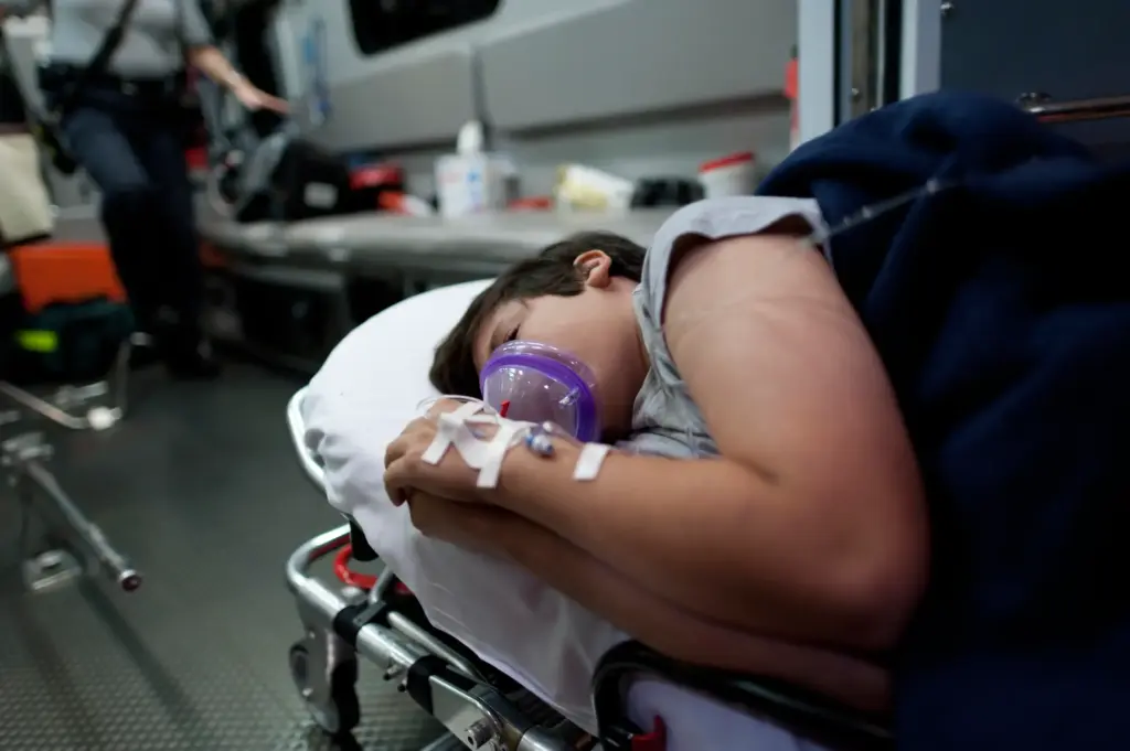 A child in the back of an ambulance.
