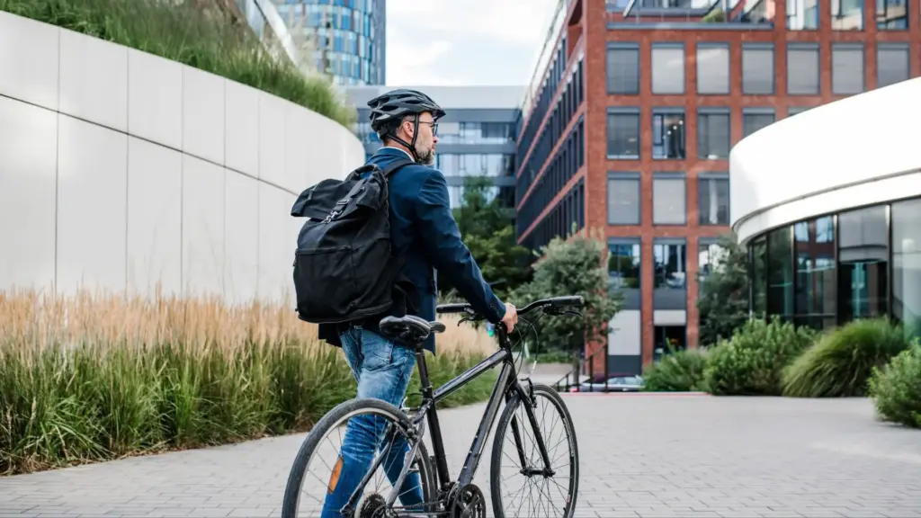 A bicyclist walking his bike to a safe area.