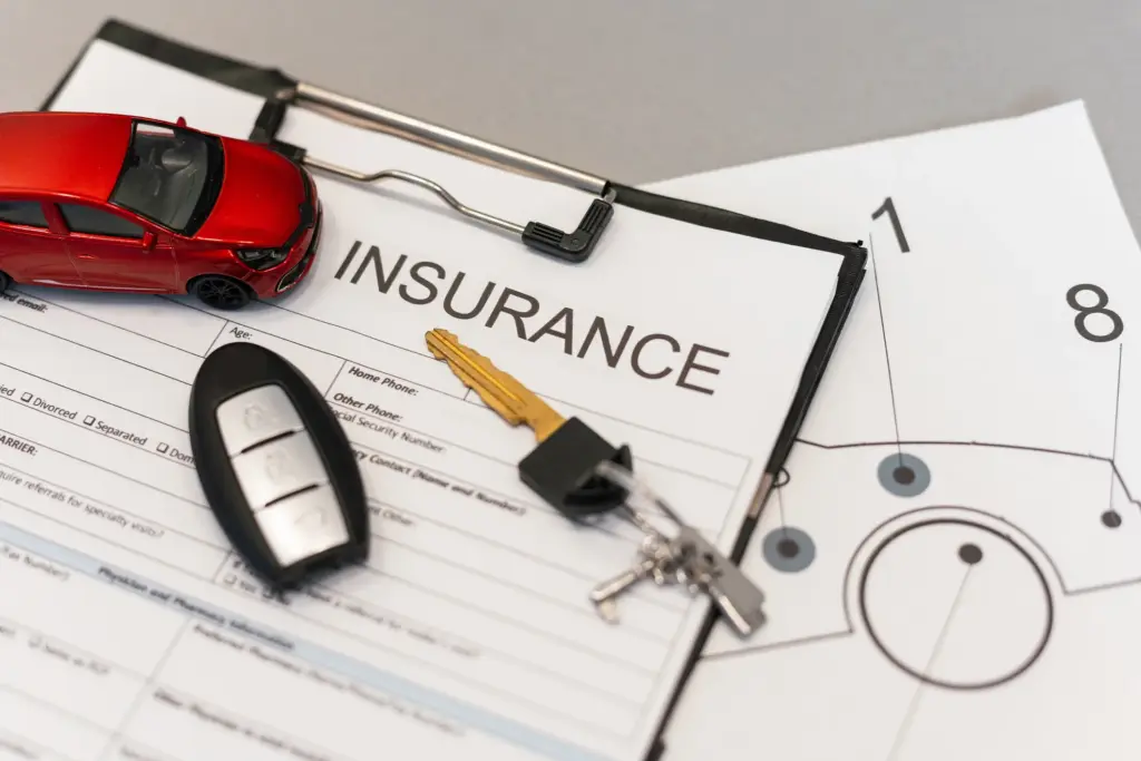 An car insurance policy with a set of keys on top.