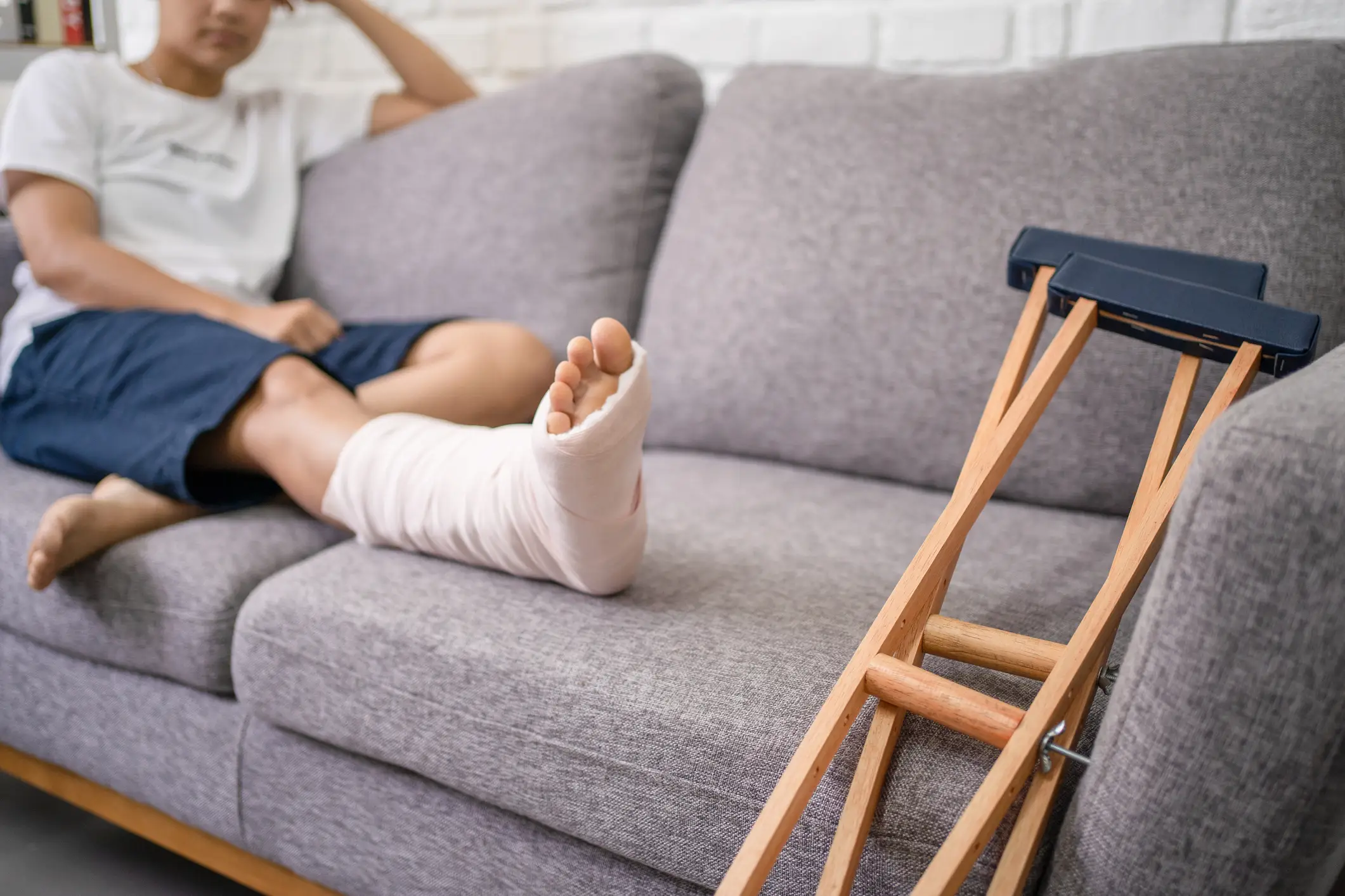 A person with a leg cast on a sofa.