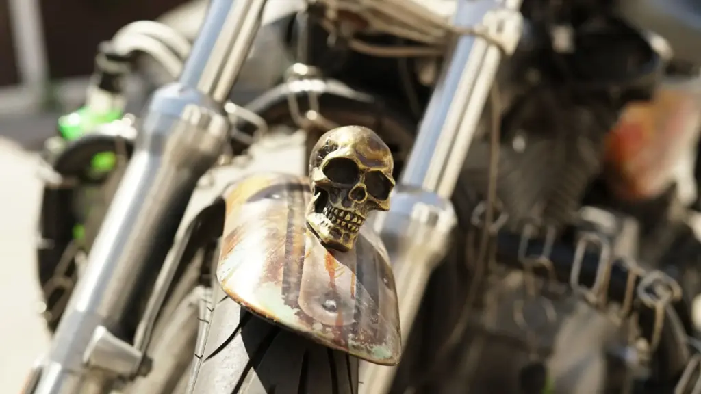 An altered motorcycle fender with a skull on top.