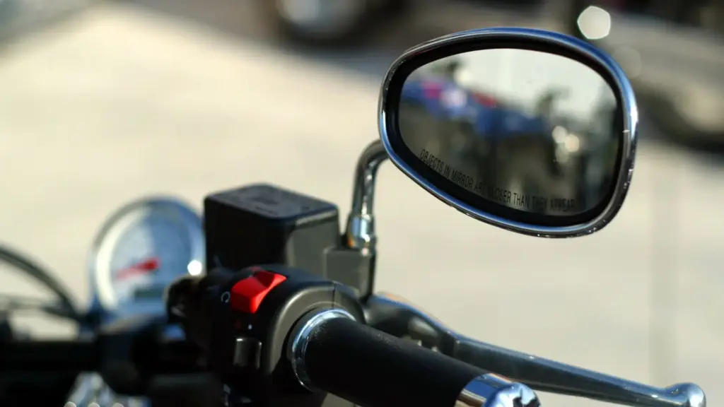 A close up of a motorcycle mirror.