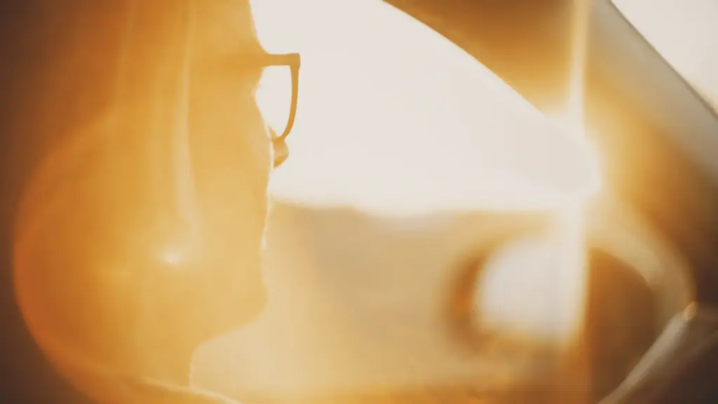 A man driving in a car and is blinded by a sun glare.