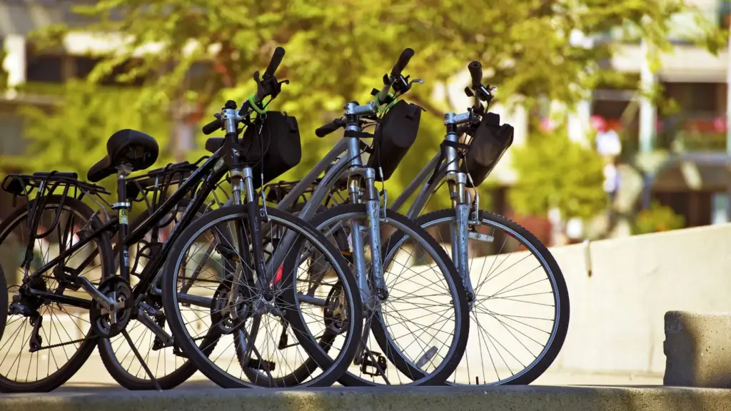 A row of bikes parked on the sidewalk. 