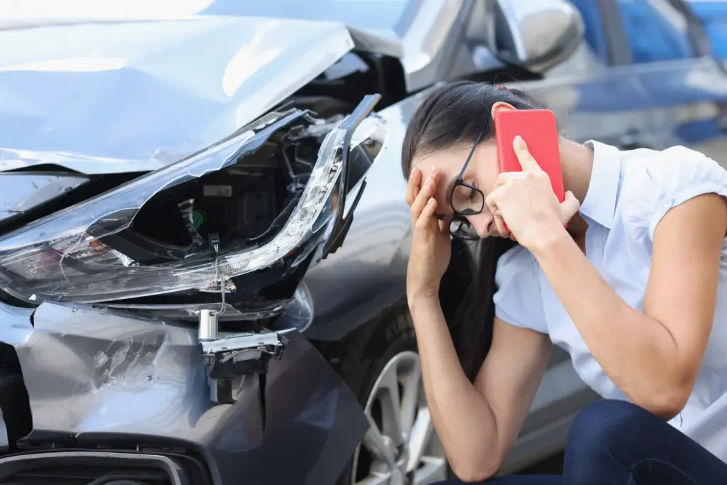 A woman on the phone after getting involved in an Arizona car accident.