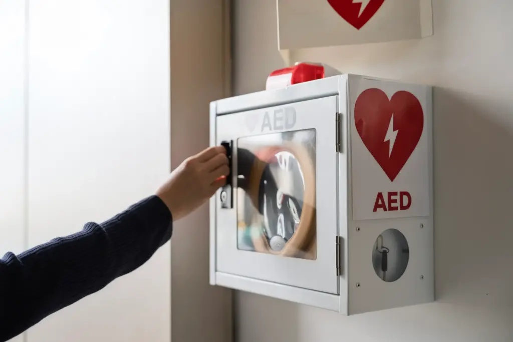 A person reaching for a AED to rescue someone.