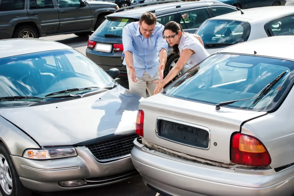 A car accident in a parking lot where two drivers are disputing fault. 