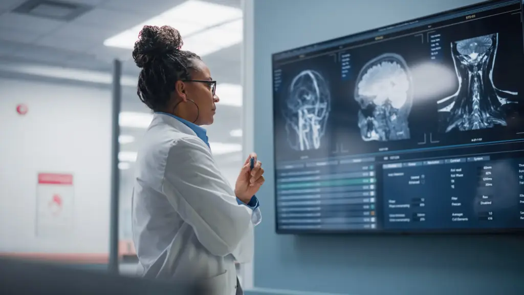 A doctor examining x-rays of a patients brain.