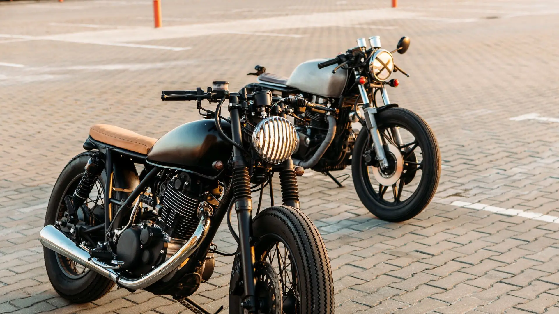 A pair of motorcycles that has no side mirrors.