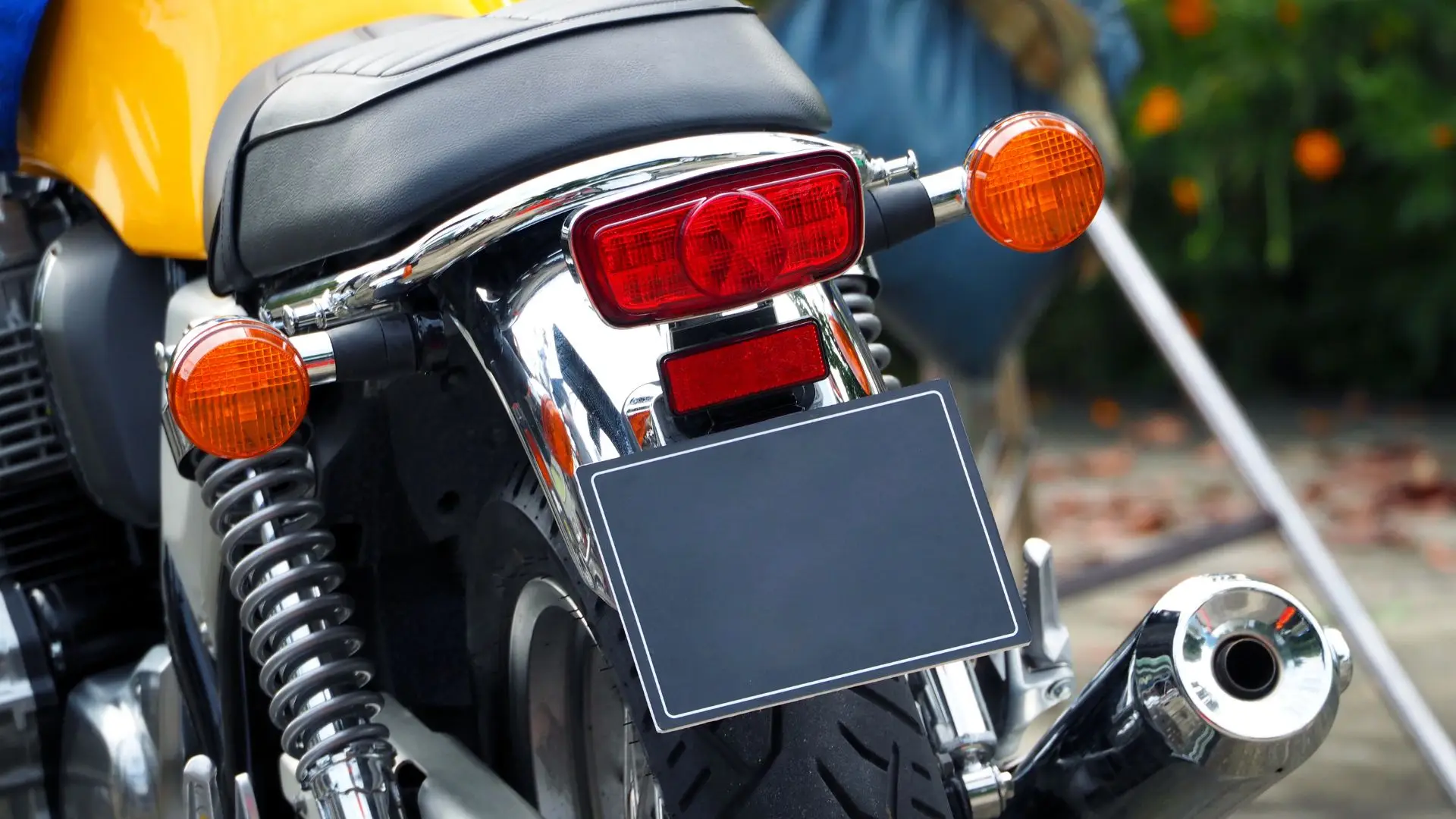 A motorcycle with a blacked out license plate.