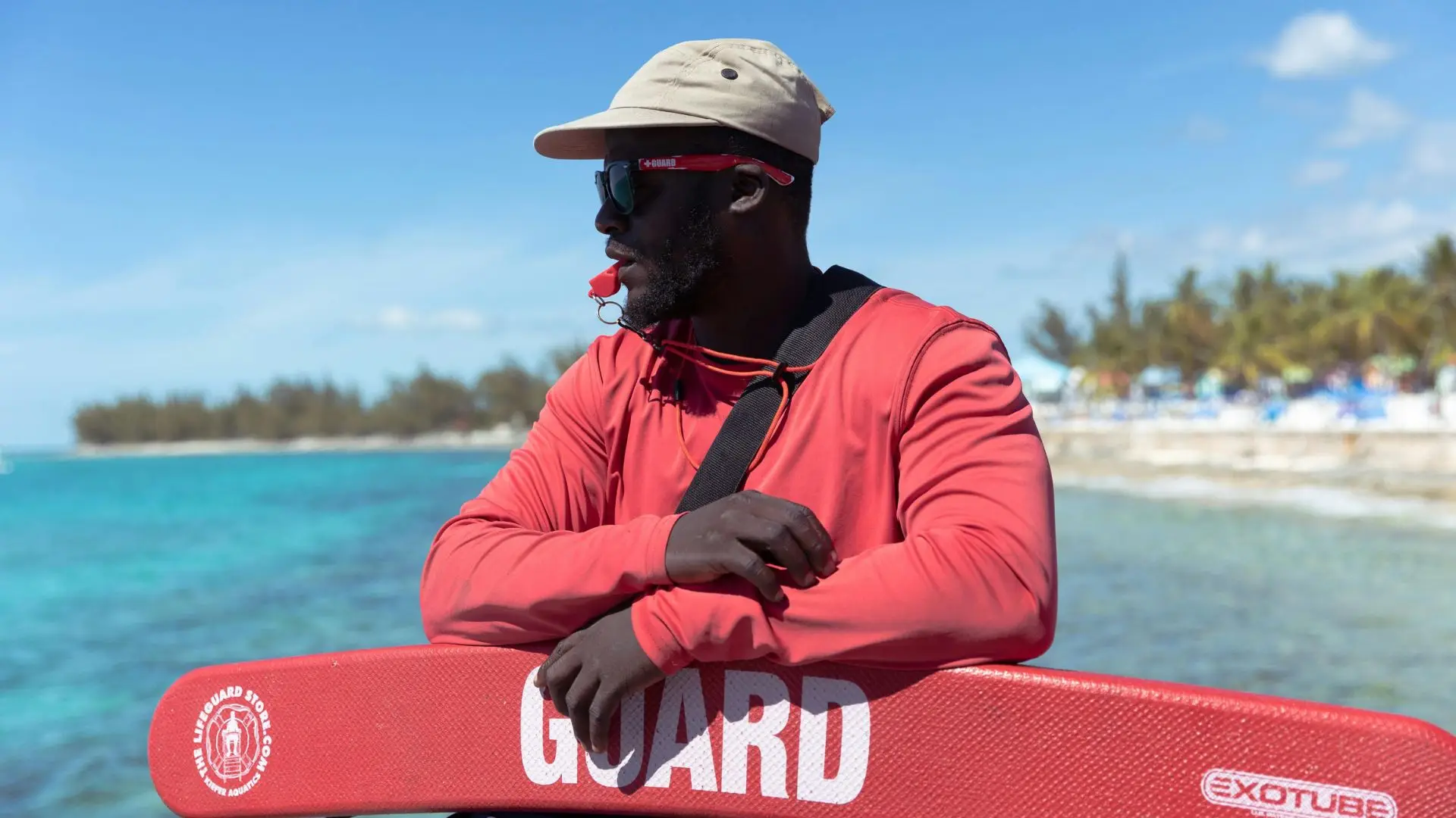A lifeguard casually watching for any drownings.