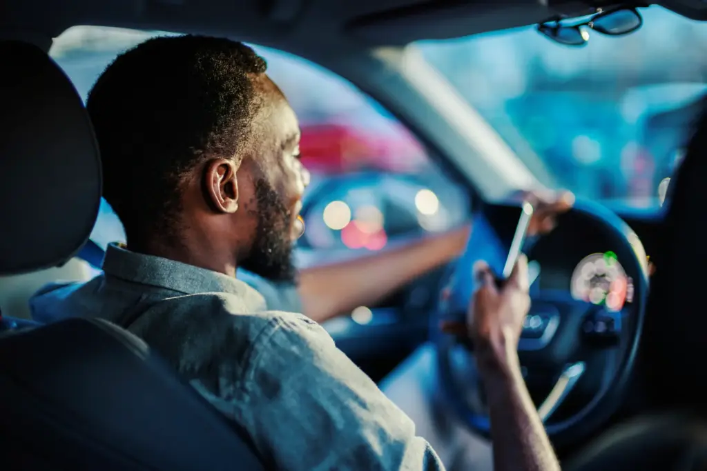 A driver looking at his phone while actively driving.
