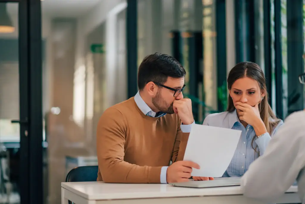 A couple getting bad news from their insurance adjuster.