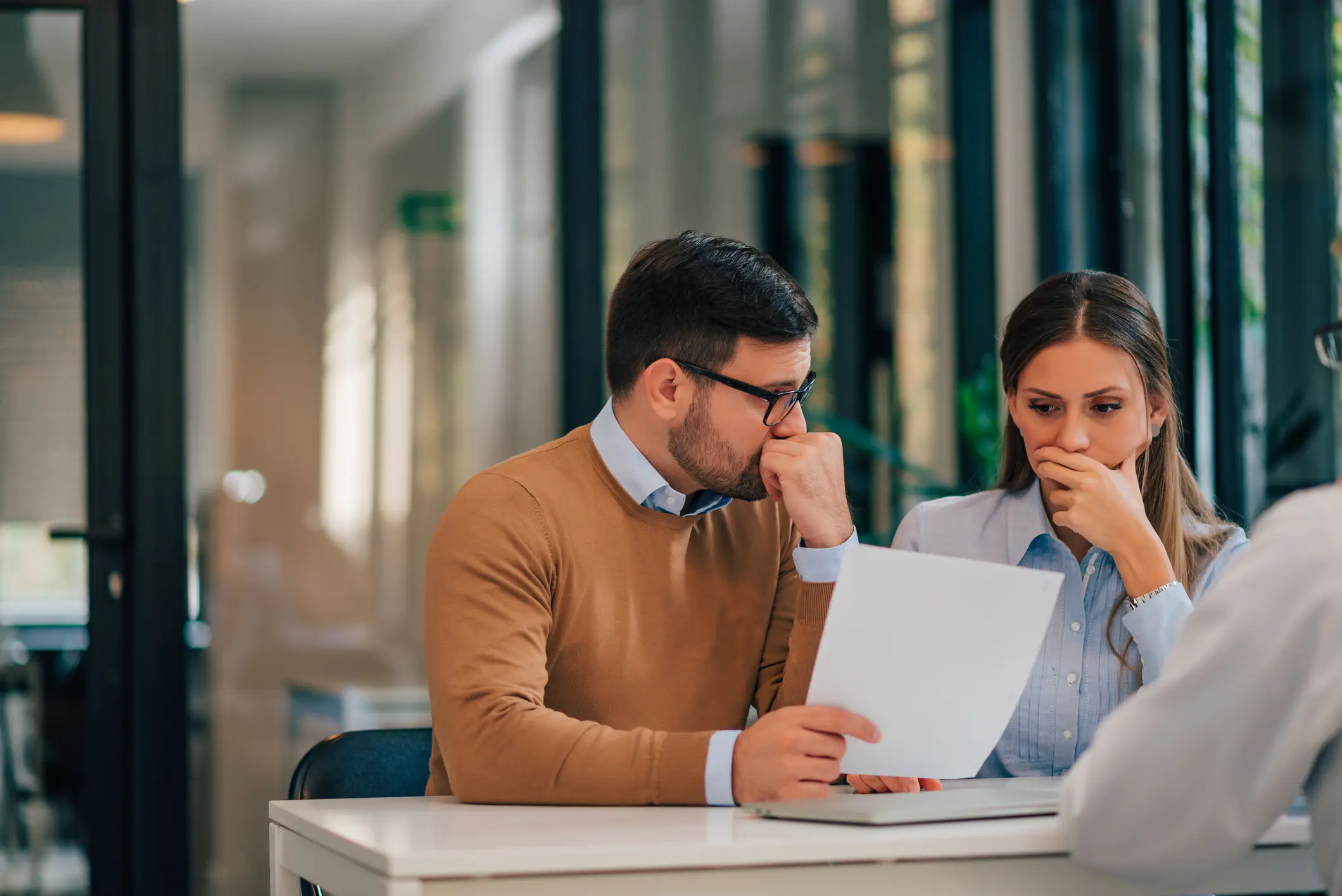 A couple getting bad news from their insurance adjuster.