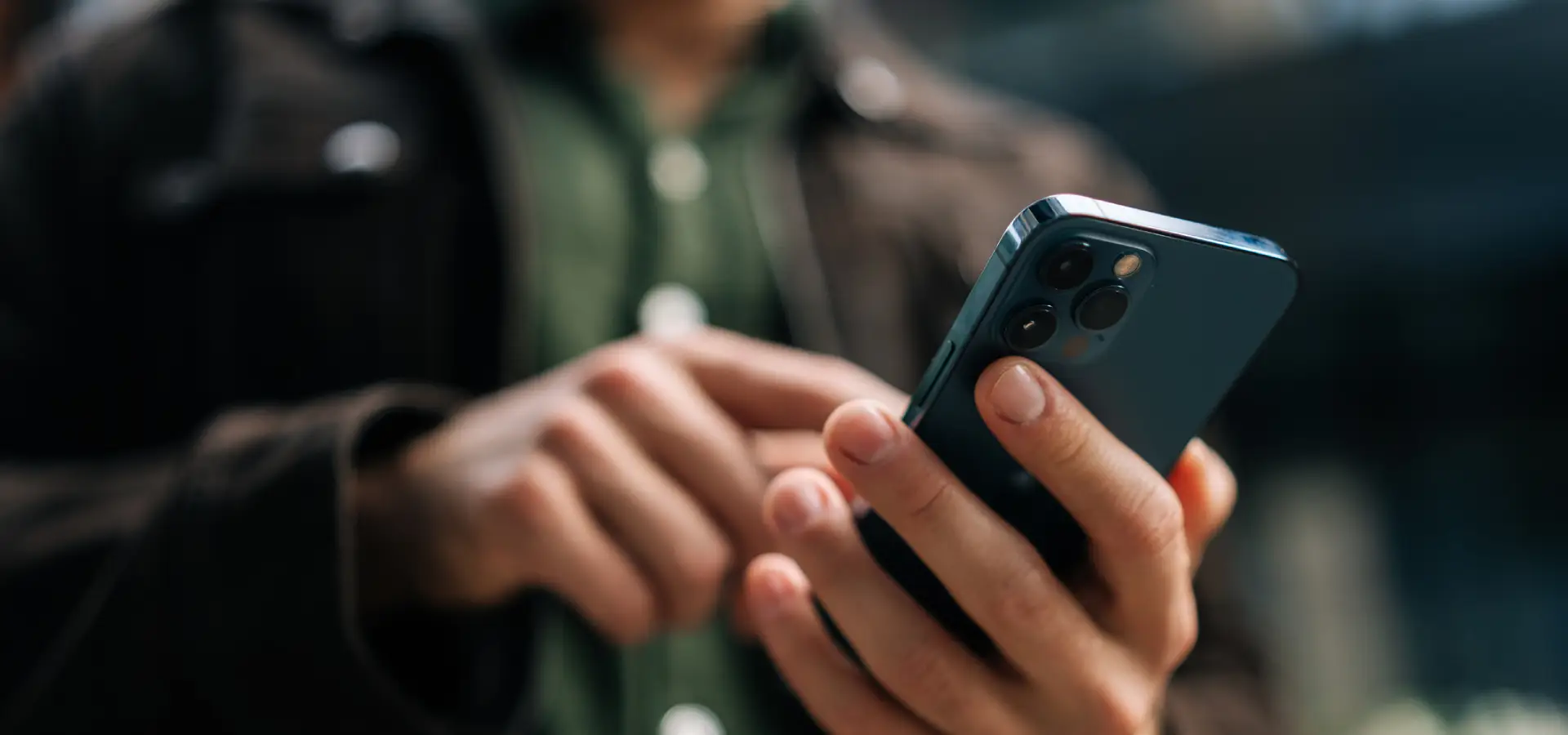 A man looking up an attorney on his phone.