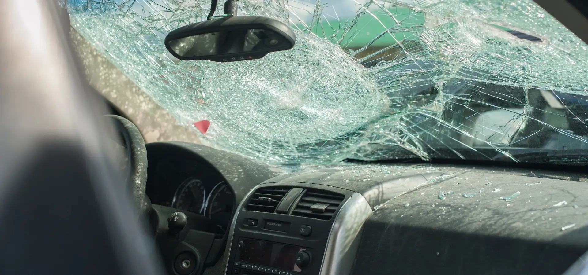 A car with a severely cracked windshield.